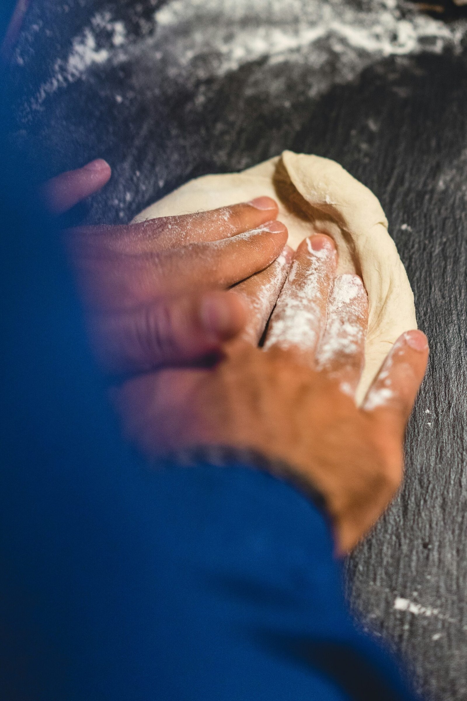 a person is kneading dough on a table